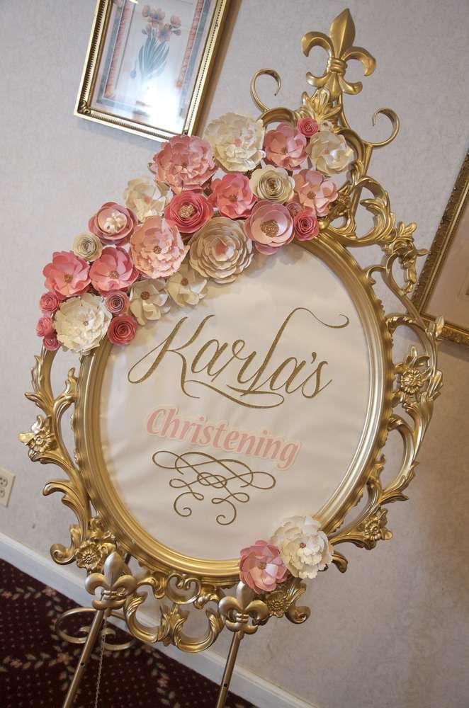 an ornate gold frame with pink flowers on it