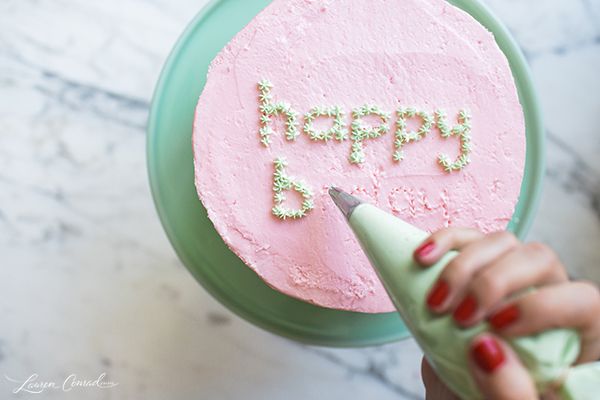 a pink cake with the words happy birthday written on it