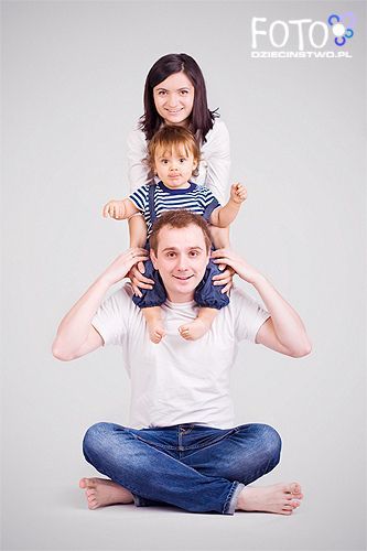 a man is sitting on the floor with two children