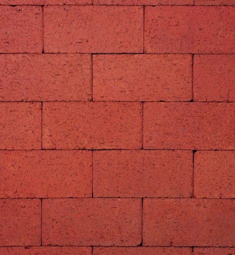 a red brick wall that is very close to the ground with no bricks on it