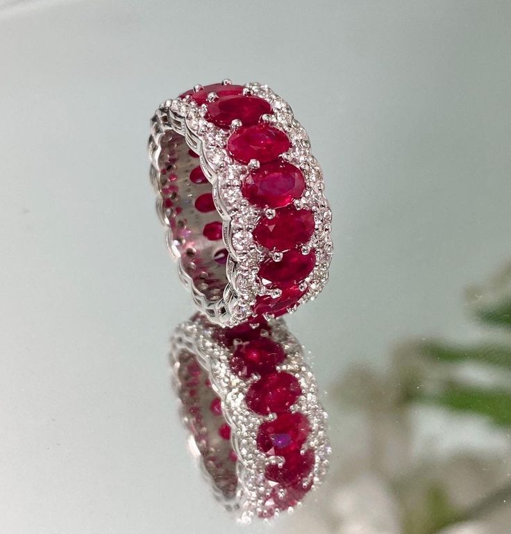 Brand new ruby and diamond eternity band - a must-have piece for your complete ring stack! Perfectly matched 6x4 mm rubies are set in a well crafted eternity style in 18K white gold surrounded by diamonds. DETAILS ❤️Ruby Weight: 9.17 CT 📏Ruby Measurements: 6x4 mm 💎Diamond Weight: 1.52 CT 💍18K White Gold 🎂Birthstone: July STYLES This ring can be made to order in precious gemstones such as emerald and sapphire. CUSTOM ORDER We customize high jewelry made with quality gemstones and diamonds. Pl Rubies And Diamonds Ring, Ruby Oval Ring, Ruby Jewelry Ring, Ring Photoshoot, Ruby Eternity Ring, Ruby Eternity Band, Jewelry Ruby, Ruby And Diamond Ring, Ruby Birthstone