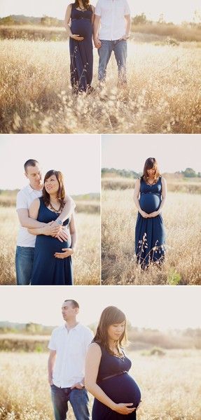 a pregnant couple standing in the middle of a field with their belly wrapped around each other