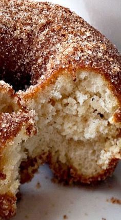 a close up of a doughnut on a plate with sugar sprinkled on it