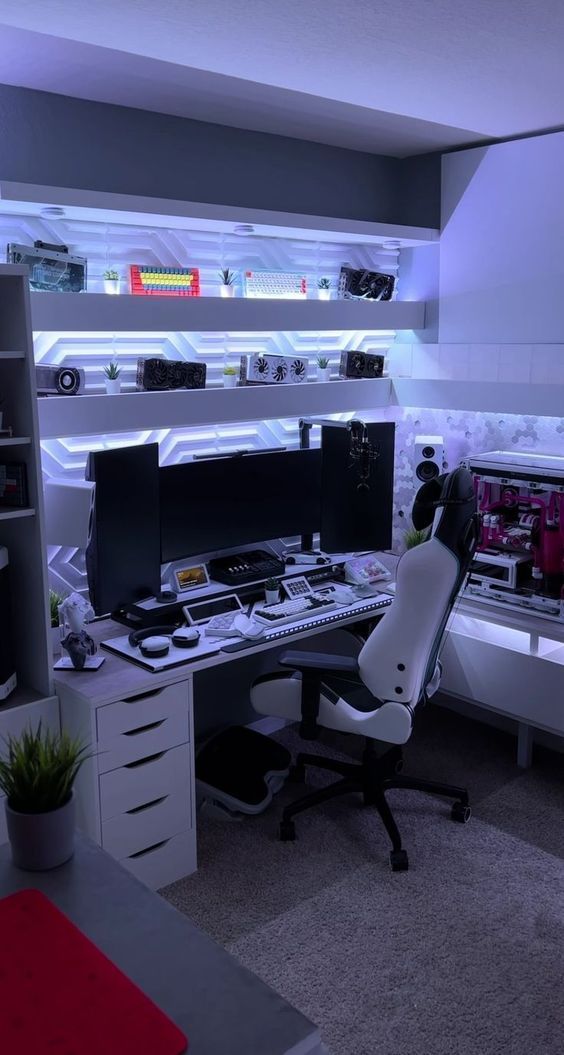 a desk with two computer monitors on top of it and a chair in front of it