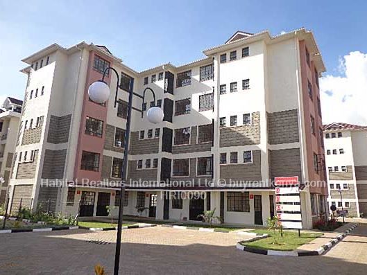 an apartment building with several balconies on the second floor