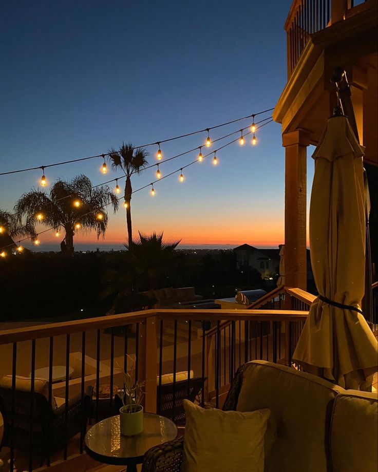 the patio is lit up with string lights