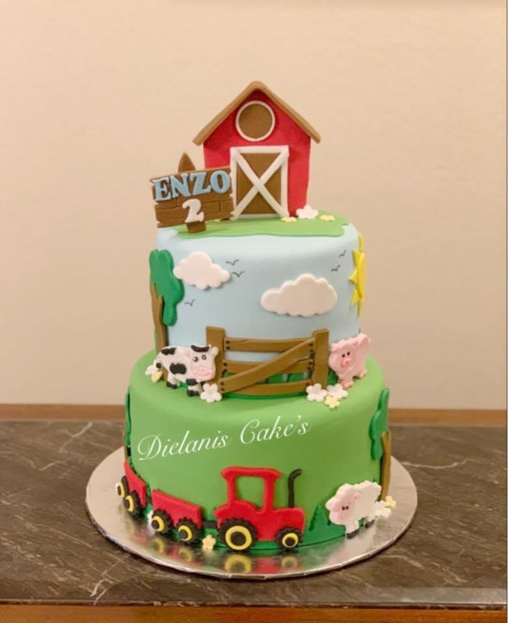 a three tiered cake with farm animals on the front and sides, sitting on a table