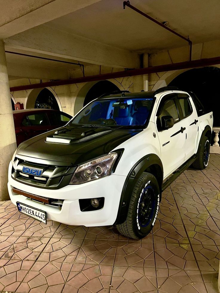 a white pick up truck parked in a parking garage