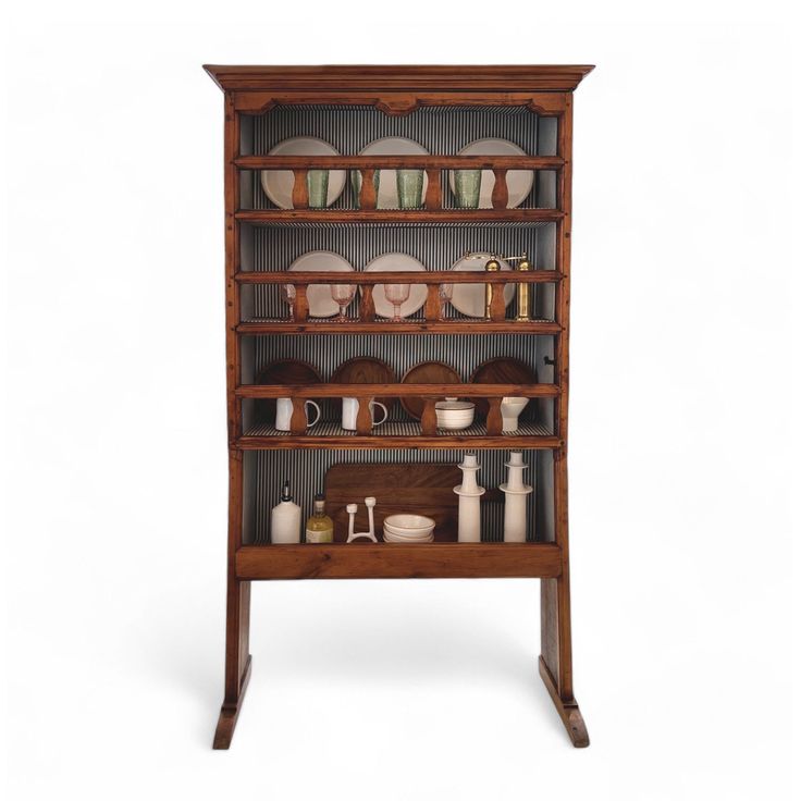 an old fashioned wooden shelf with dishes on it