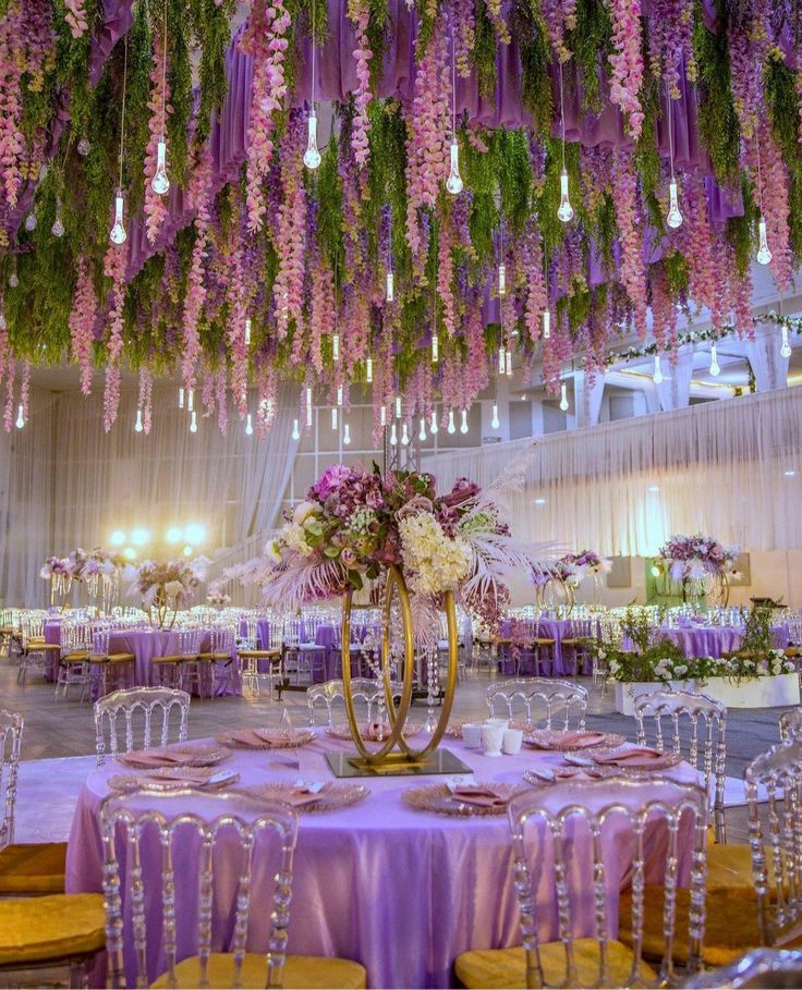 a long table is set up with white flowers and candles for an elegant wedding reception