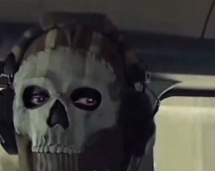 a skull with headphones on sitting in a car