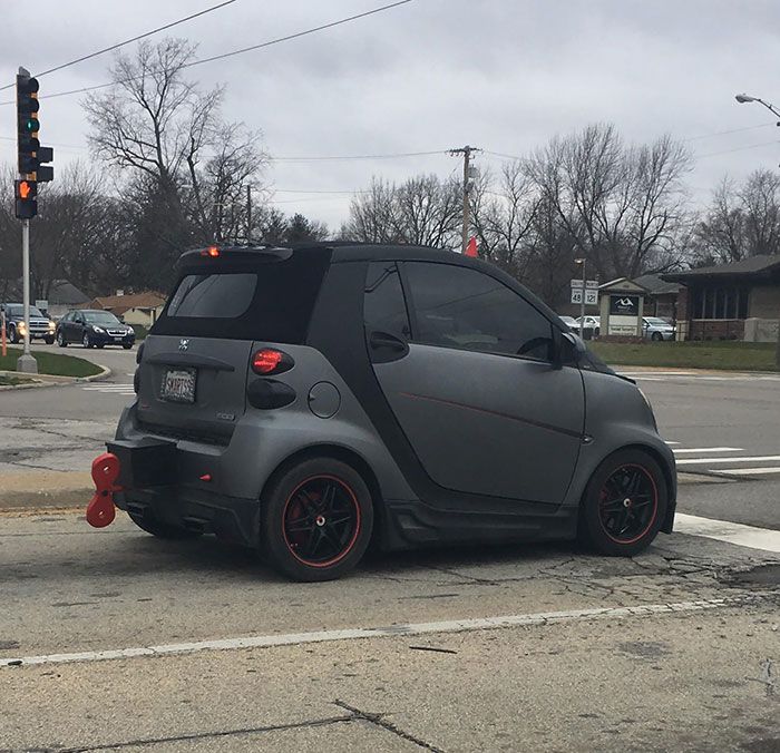 a smart car is parked at an intersection