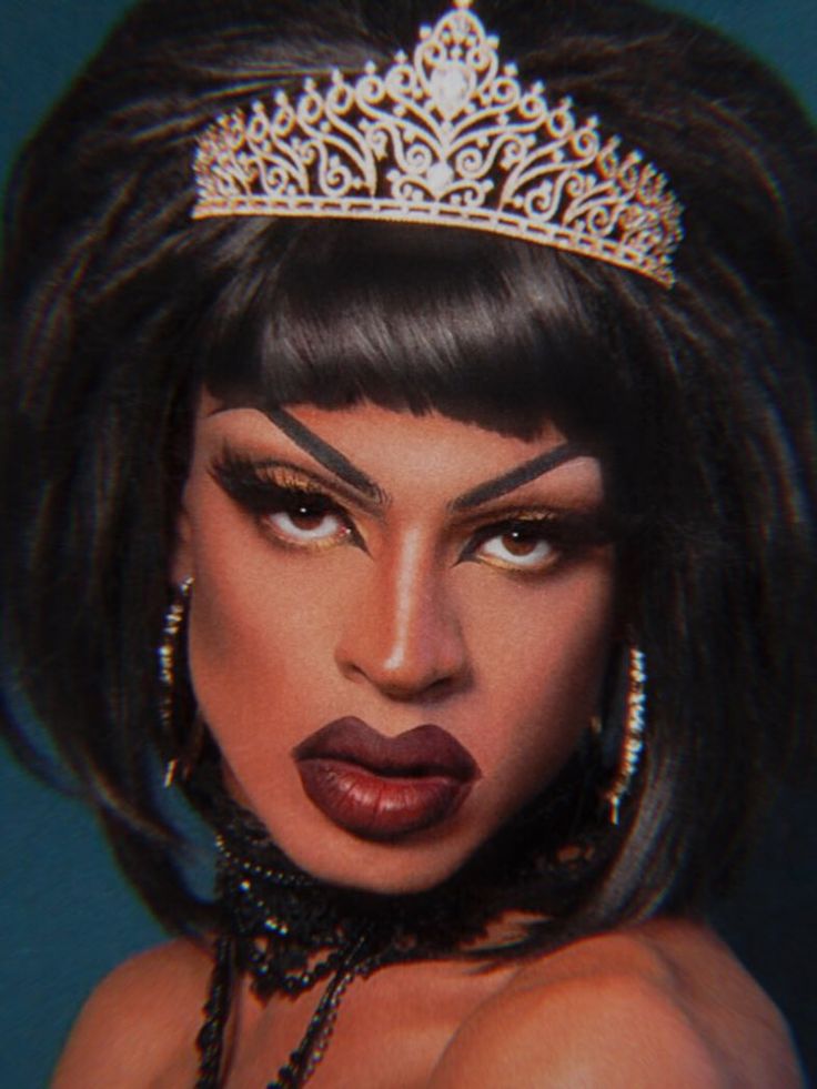 a woman wearing a tiara and lipstick