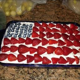 an american flag cake with strawberries on it