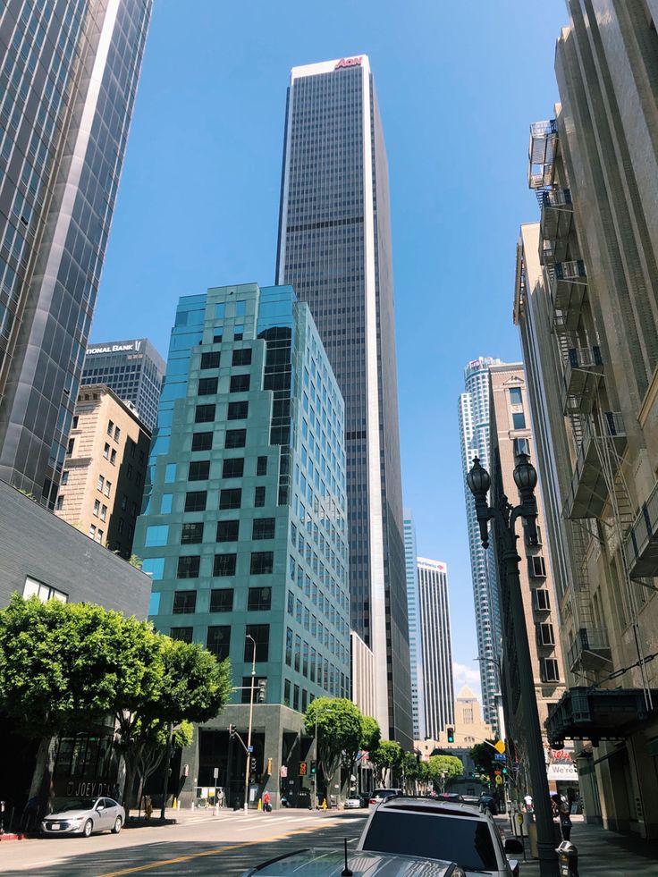 an empty city street with tall buildings in the background