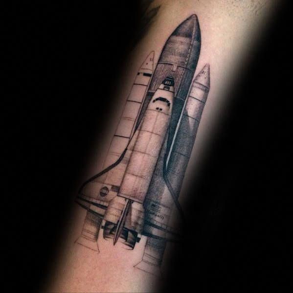 a black and white photo of a space shuttle tattoo