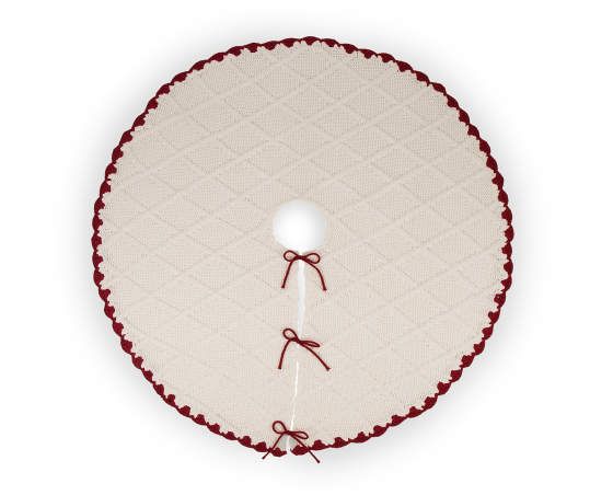 a white and red round table cloth with two ties on the edge, hanging from a hook