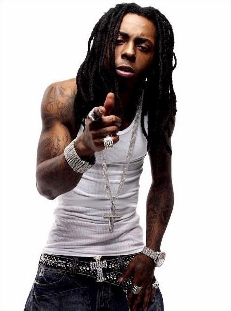 a man with dreadlocks pointing to the side while wearing a white tank top