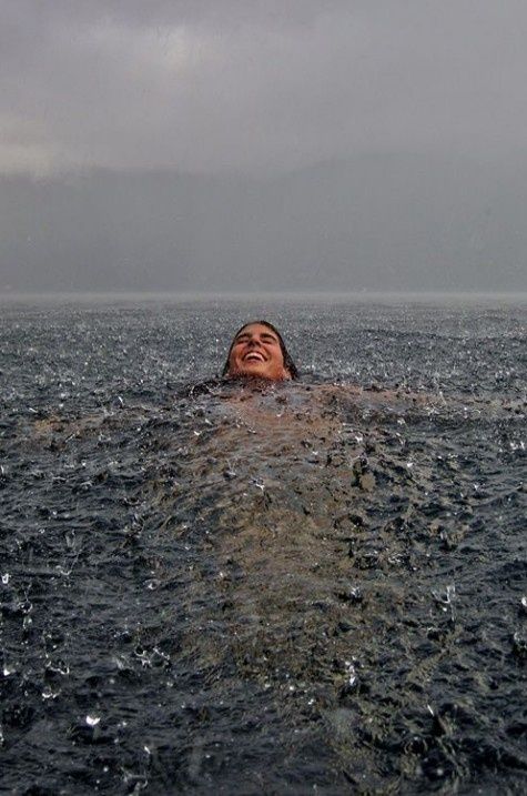 a woman floating in the water with her eyes closed