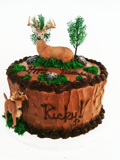 a cake with deer and trees on it