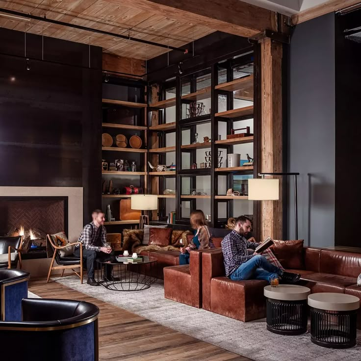 three people sitting on couches in a living room