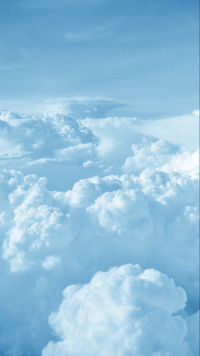 an airplane is flying high above the clouds