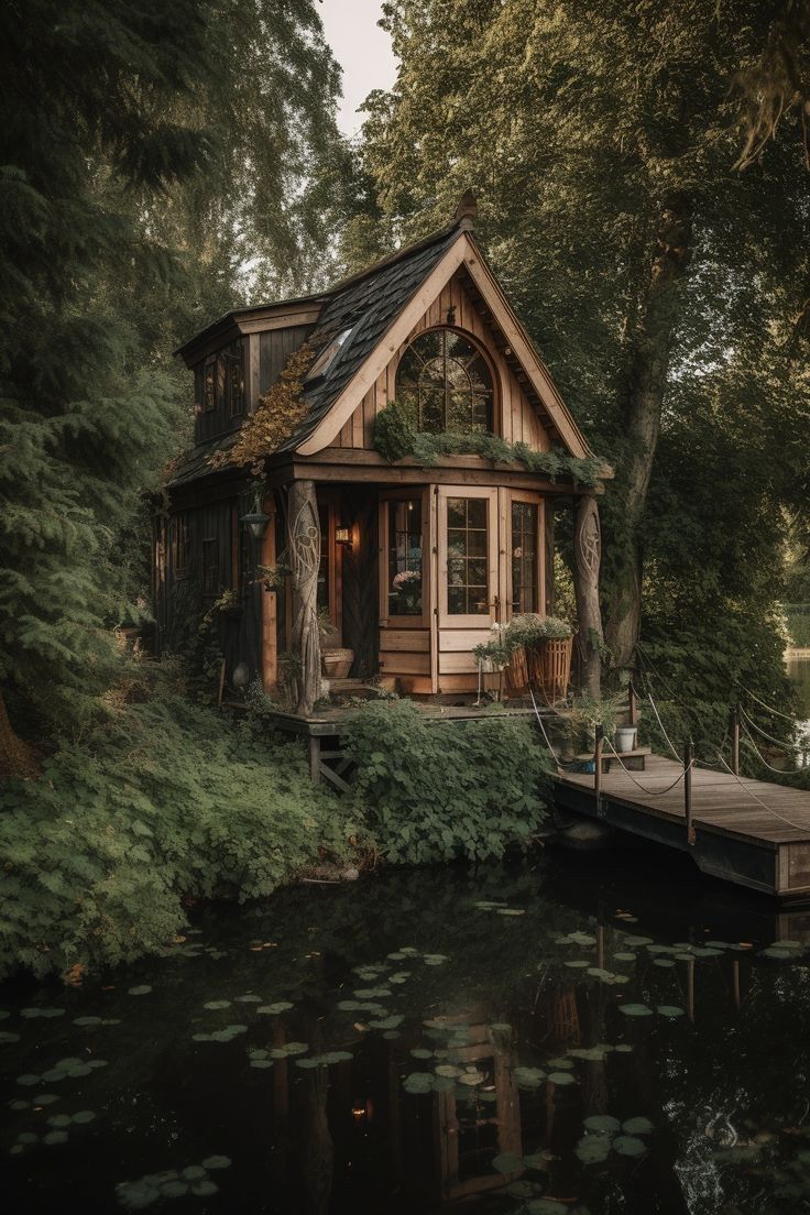 a small cabin sits on the edge of a lake with water lilies around it