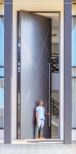 a man standing in front of a large door