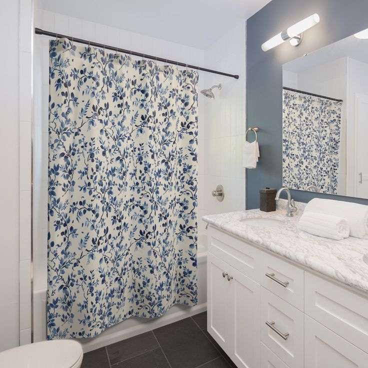 a bathroom with blue and white shower curtain