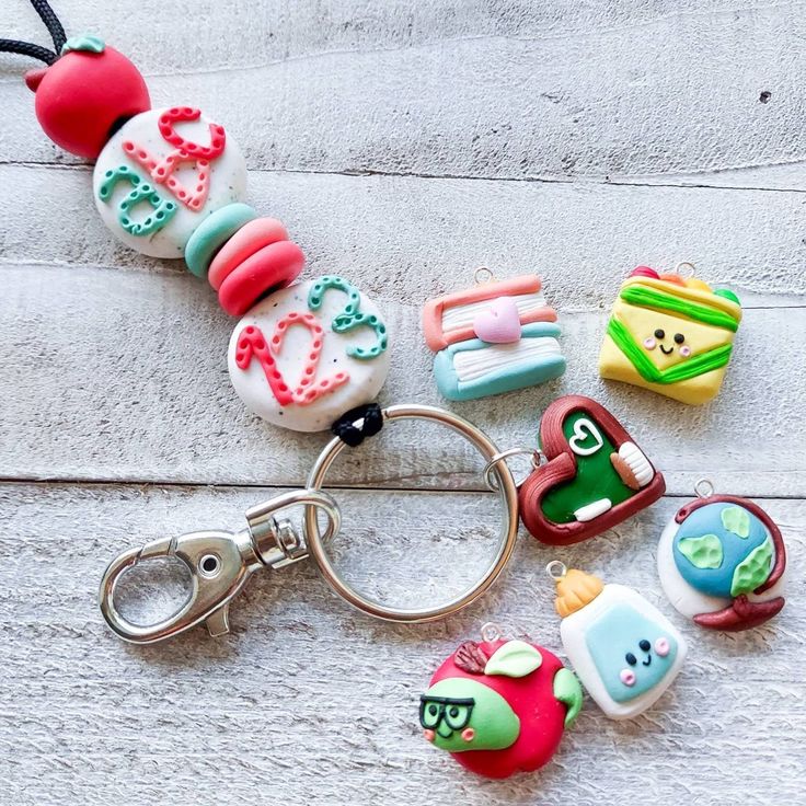 a keychain that has some kind of items in it on the ground next to each other