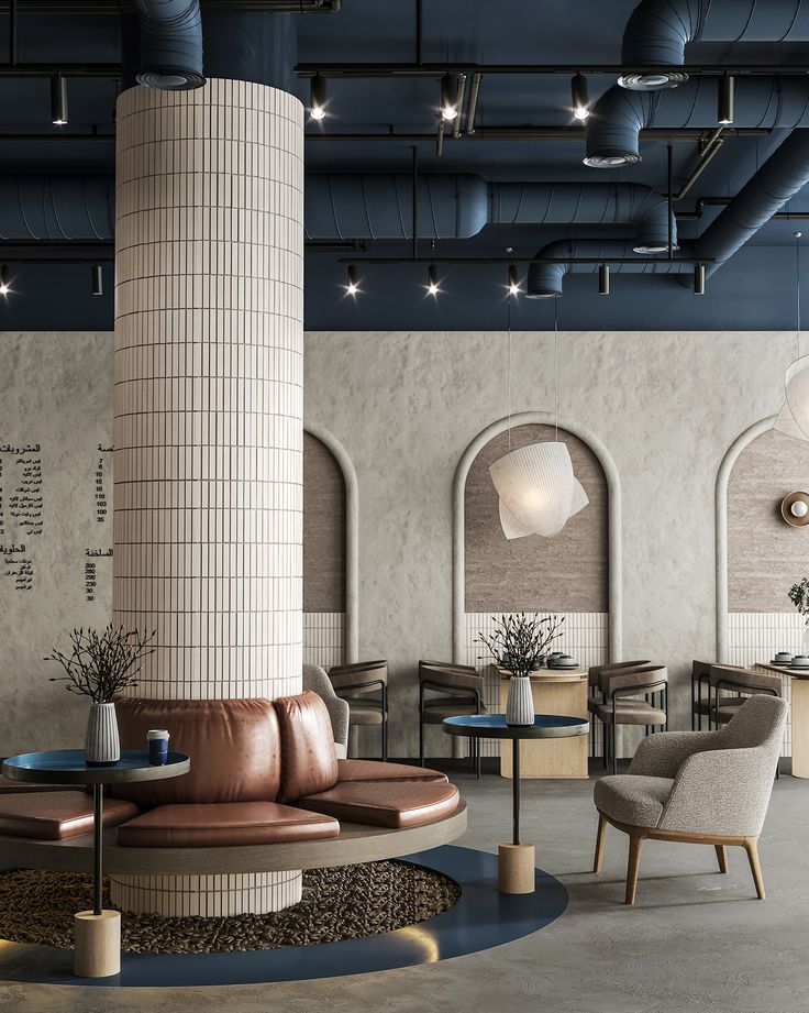 the interior of a modern restaurant with round tables and leather chairs, exposed pipes and windows