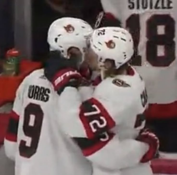 two hockey players standing next to each other