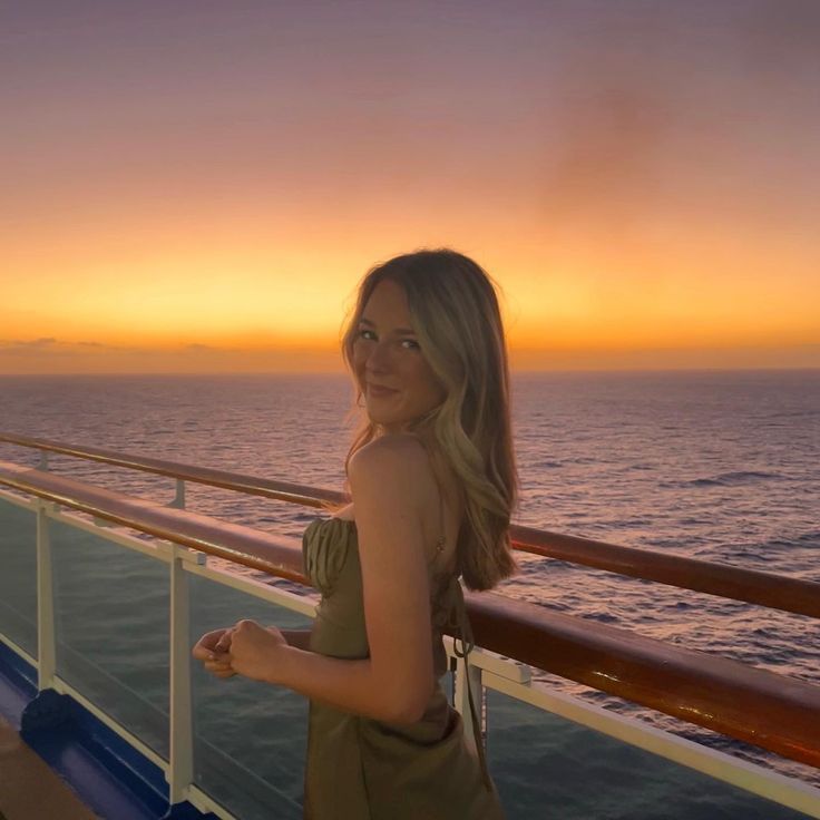 a woman standing on the deck of a cruise ship