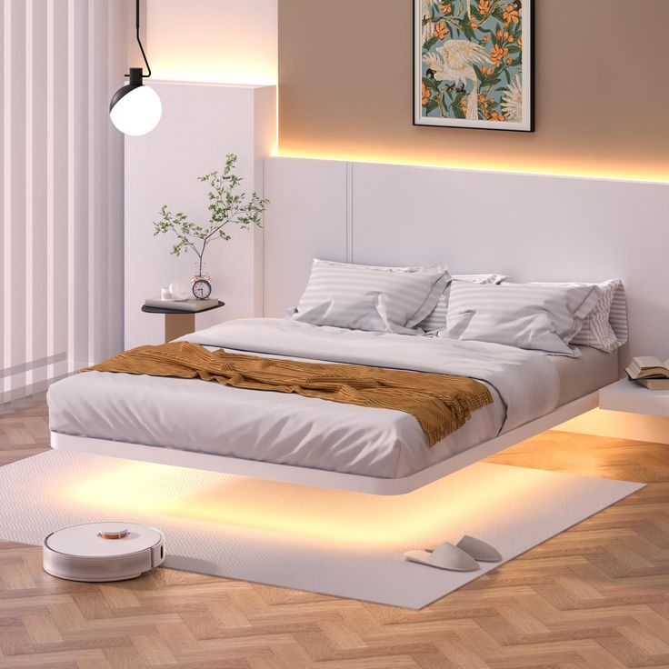 a bed with white sheets and pillows in a room that has wood flooring on it