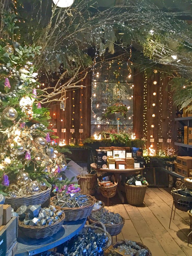 a room filled with lots of different types of christmas decorations and lights hanging from the ceiling