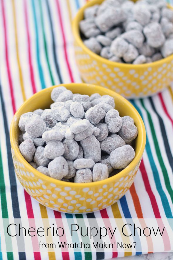 two yellow bowls filled with puppy chow sitting on top of a striped table cloth next to each other