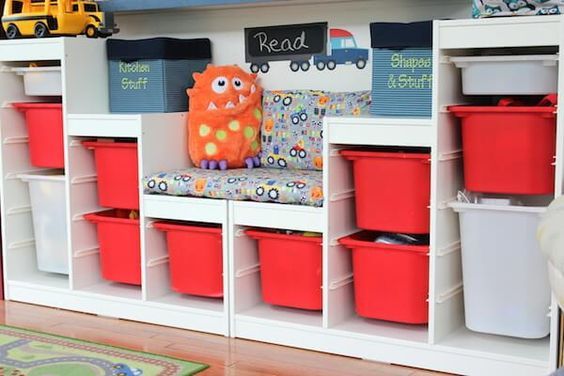 a child's playroom with toys and storage bins on the shelves,