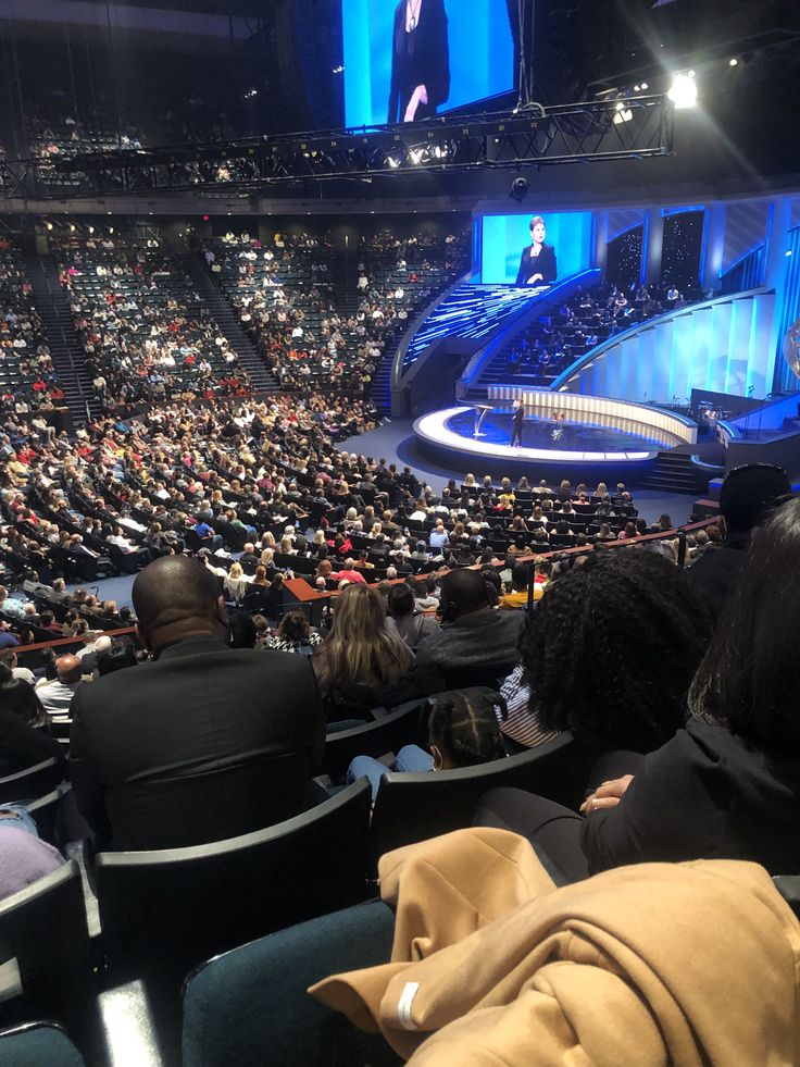 an auditorium filled with people sitting in chairs