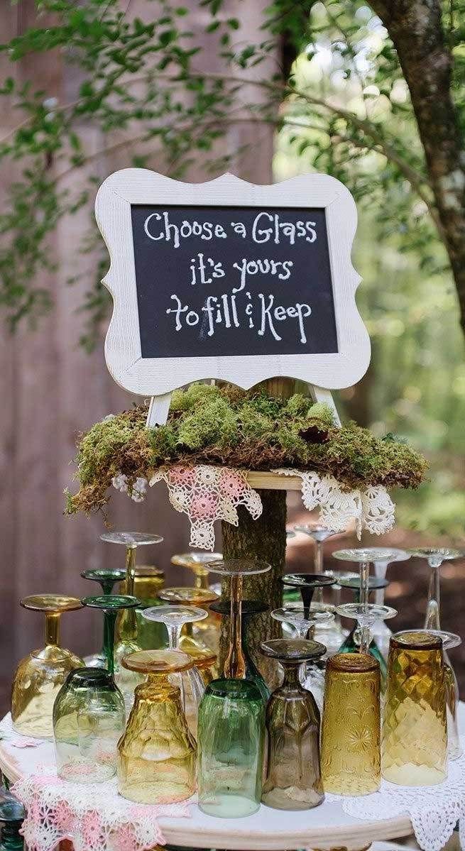 a table topped with lots of jars and bottles filled with moss on top of it