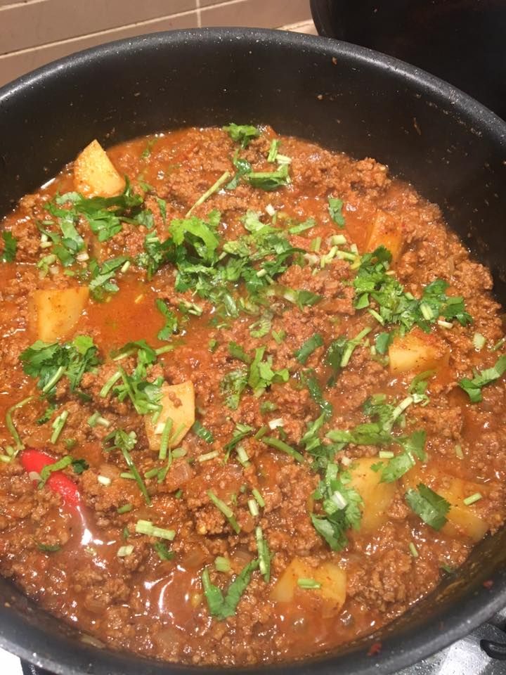 a pan filled with food sitting on top of a stove