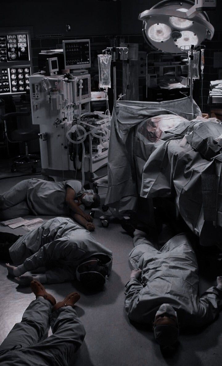 some people are laying on the floor in a room with many medical equipment and lights