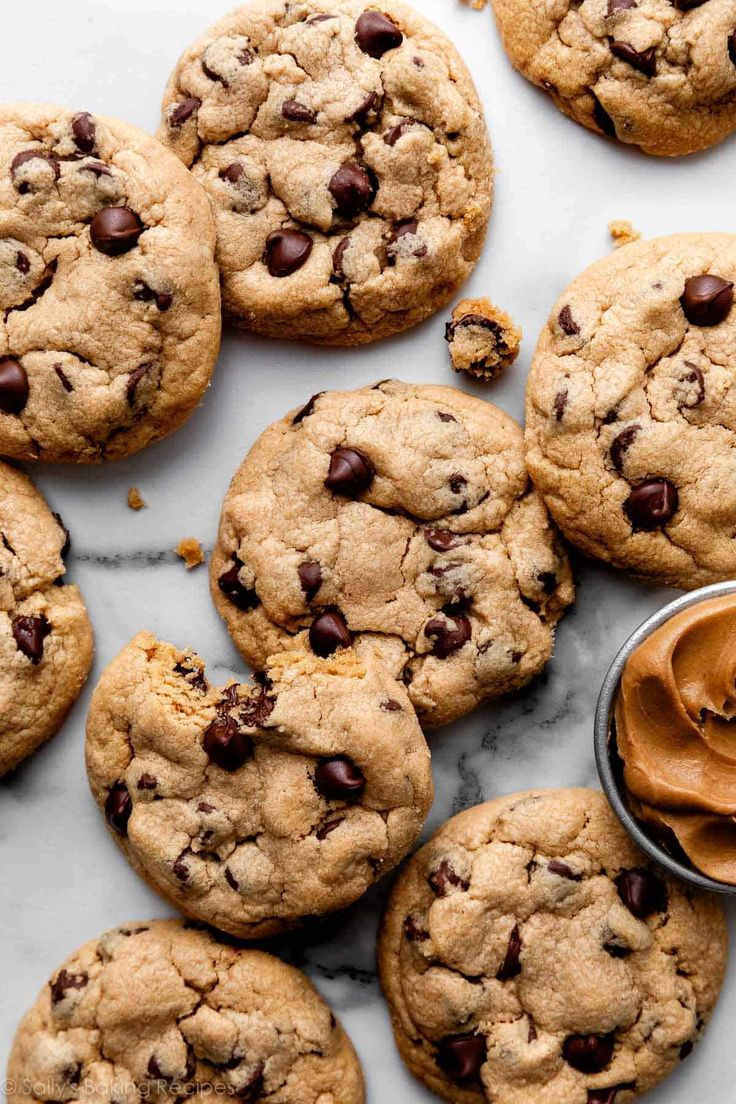 chocolate chip cookies with peanut butter spread on the top and one cookie in the middle