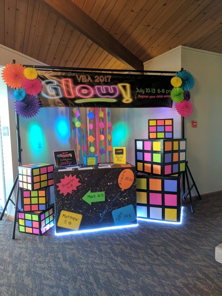 a colorful display in the middle of a room with lights and decorations on it's sides