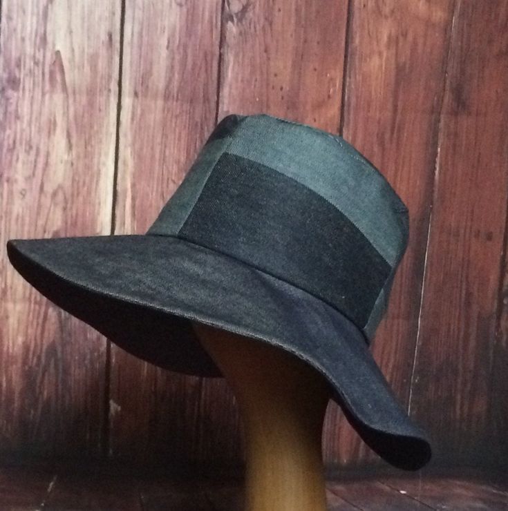 "Wide Brim Sun Hat upcycled denim unique patchwork Inside is a black cotton band, the hat has a 2 section crown 3 1/2 \" in length and a one piece 4\" brim and its lined in a cotton blend print keeps the head cool. This hat is one size fits all and will fit 21\" - 23\" head size. All of Bella Starr hats are made and designed from my drafted original patterns. Caring for your hat: Machine wash on gentle and hand dryPlease contact Bella Starr immediately if your not satisfied with your purchase. I Black Reversible Brimmed Hat, Black Reversible Sun Hat With Curved Brim, Adjustable Cotton Patchwork Hat, Packable Hat, Floppy Sun Hats, Boho Hat, Wide Brim Sun Hat, Patchwork Denim, Denim Hat