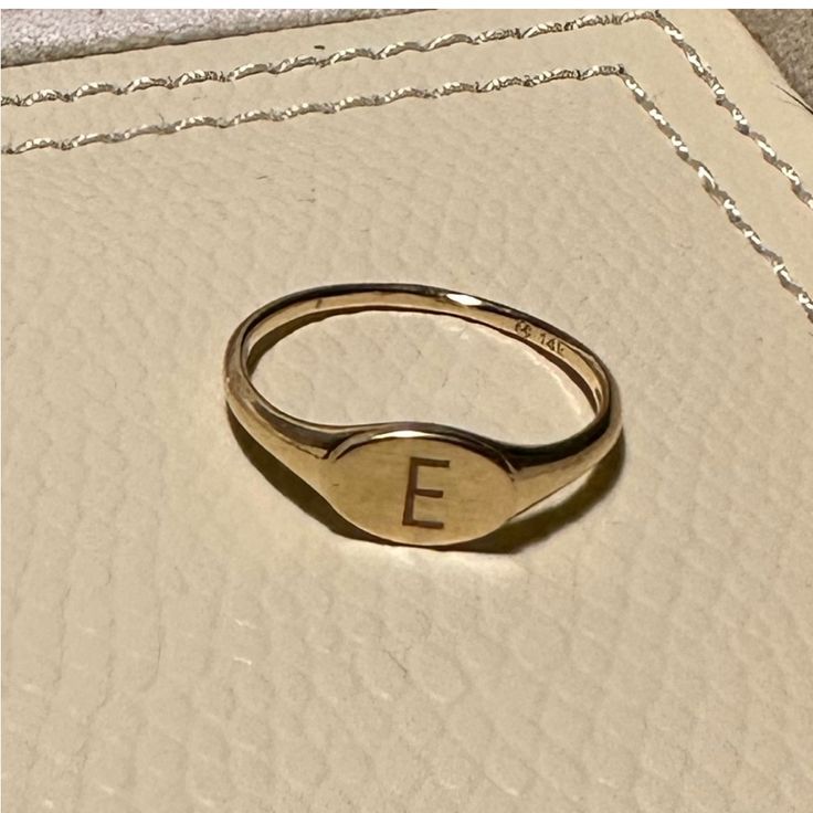 Mejuri Signet Ring 14k Gold Size 7.75 Engraved With The Letter E. Cute As Pinky Ring Or Accent Ring. Custom-Made And Resized Yellow Gold 14k Mejuri Ring In About A Size 7.75 With An 'E' Engraved. Has Some Tiny Marks But Is Still In Beautiful Condition. Very Lightly Worn! Top Width: 6 Mm - Shank Width: 1 Mm Mejuri Signet Ring, Mejuri Rings, Mejuri Jewelry, Letter E, Pinky Ring, Signet Ring, Gold Rings, Initials, Size 7