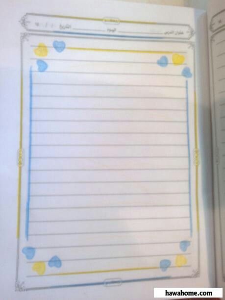 an open notebook with blue and yellow hearts on it, next to a notepad