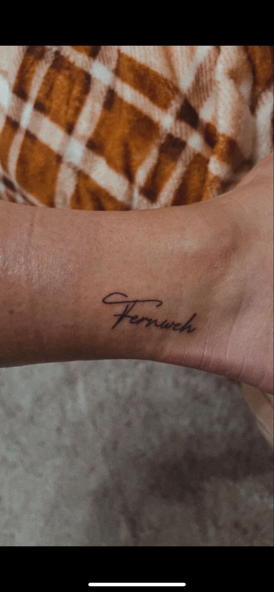 a woman's arm with the word forward tattooed on her left forearm and foot