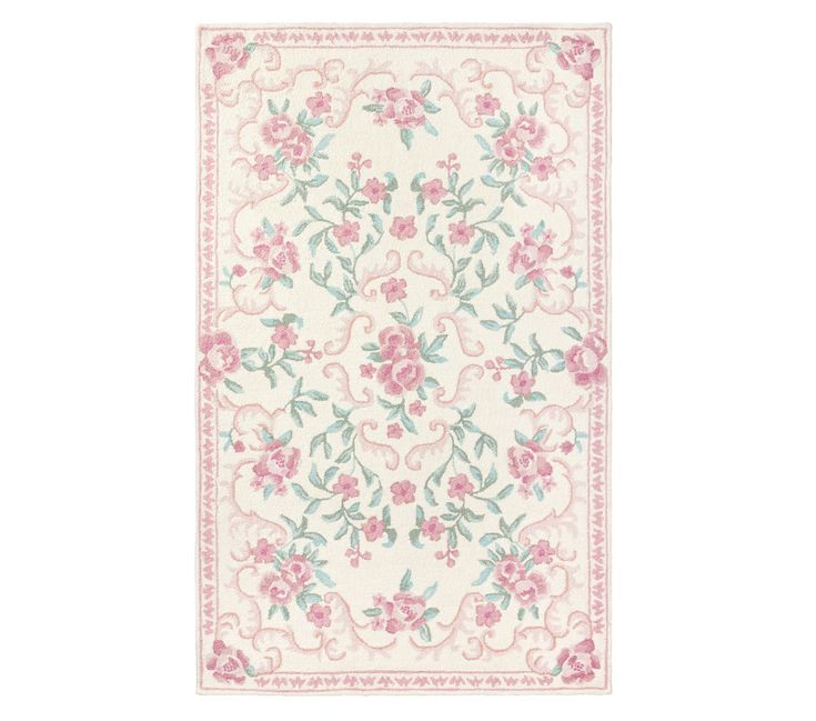 a white rug with pink flowers and green leaves on the bottom, in front of a white background