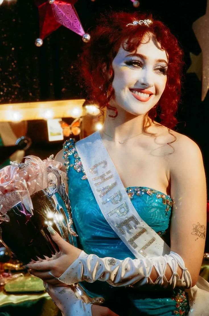 a woman wearing a tiara and holding a bouquet