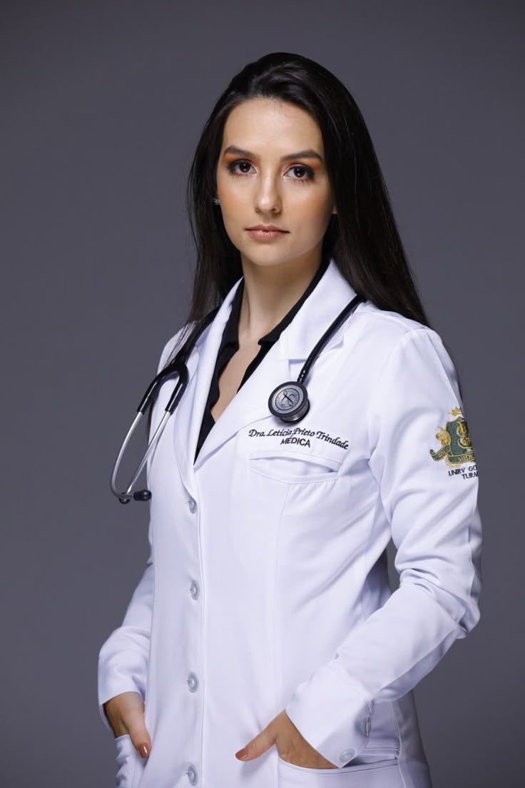 a woman wearing a white lab coat and stethoscope standing with her hands on her hips